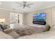 Stylish living room with large TV, modern fireplace, comfortable seating, and open layout at 8272 Summer Night Rd, Sarasota, FL 34241