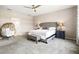 Spacious main bedroom features carpeted floors, ceiling fan, and sitting area at 8272 Summer Night Rd, Sarasota, FL 34241