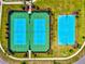 Aerial view showcasing the community's tennis and basketball courts amidst lush green landscaping at 8272 Summer Night Rd, Sarasota, FL 34241