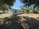 The backyard offers a well-sized lawn with fence, trees and plenty of room for outdoor activities at 8291 57Th N St, Pinellas Park, FL 33781
