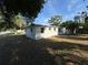 The backyard offers a well-sized lawn with fence, trees and plenty of room for outdoor activities at 8291 57Th N St, Pinellas Park, FL 33781