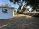 The backyard offers a well-sized lawn with fence, trees and plenty of room for outdoor activities at 8291 57Th N St, Pinellas Park, FL 33781