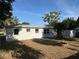 A spacious backyard featuring a fire pit and mature trees, great for outdoor relaxation and entertaining at 8291 57Th N St, Pinellas Park, FL 33781