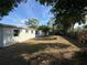 The backyard offers a well-sized lawn with fence, trees and plenty of room for outdoor activities at 8291 57Th N St, Pinellas Park, FL 33781