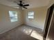 Bright bedroom with carpet, ceiling fan, and natural light from the two windows at 8291 57Th N St, Pinellas Park, FL 33781