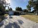 A single-story home with a garage and a well-maintained driveway, showcasing convenient parking and curb appeal at 8291 57Th N St, Pinellas Park, FL 33781