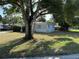 A charming single-story home featuring a lush front yard and mature trees, offering great curb appeal at 8291 57Th N St, Pinellas Park, FL 33781