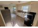 Bright kitchen with white cabinetry, stainless steel appliances, and tile flooring at 8291 57Th N St, Pinellas Park, FL 33781