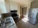 Kitchen view with stainless steel refrigerator and oven, and overhead shelving at 8291 57Th N St, Pinellas Park, FL 33781