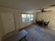 Bright living room featuring multiple windows, ceiling fan and front door at 8291 57Th N St, Pinellas Park, FL 33781