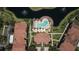 Aerial view showcasing community pool, seating, landscaping, and nearby lake with fountains at 8341 38Th Street Cir E # 303, Sarasota, FL 34243
