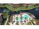 Aerial view showcasing the community pool, lake, and manicured grounds creating a tranquil oasis at 8341 38Th Street Cir E # 303, Sarasota, FL 34243