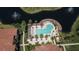 Aerial view of the swimming pool, seating areas, manicured landscaping, and a nearby lake with fountains at 8341 38Th Street Cir E # 303, Sarasota, FL 34243