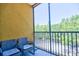 Screened in balcony with seating and a view of lush greenery and neighboring buildings at 8341 38Th Street Cir E # 303, Sarasota, FL 34243