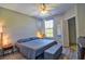 Comfortable bedroom featuring a ceiling fan and a large window allowing for natural light at 8341 38Th Street Cir E # 303, Sarasota, FL 34243