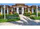 Stunning clubhouse exterior featuring vibrant colors, lush landscaping, covered entry, and ample seating at 8341 38Th Street Cir E # 303, Sarasota, FL 34243