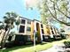 Beautiful condo building featuring balconies, lush landscaping, and a designated accessible parking area at 8341 38Th Street Cir E # 303, Sarasota, FL 34243