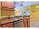 Kitchen with wooden cabinets, stylish countertops, stainless steel dishwasher and an eat-in breakfast bar at 8341 38Th Street Cir E # 303, Sarasota, FL 34243