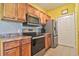 Kitchen featuring stainless steel appliances, wooden cabinets, and stylish countertop, ideal for modern cooking needs at 8341 38Th Street Cir E # 303, Sarasota, FL 34243