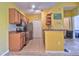 Well-lit kitchen features wooden cabinets, stainless steel appliances, and neutral tile flooring at 8341 38Th Street Cir E # 303, Sarasota, FL 34243