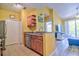 Kitchen with stainless steel dishwasher, eat-in bar area, wood cabinets, and an open layout to the living spaces at 8341 38Th Street Cir E # 303, Sarasota, FL 34243