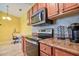 Galley kitchen with stainless steel appliances, wooden cabinets, and a cozy breakfast nook with natural light at 8341 38Th Street Cir E # 303, Sarasota, FL 34243