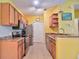 Bright kitchen features stainless appliances, wooden cabinets, tile floor and a breakfast bar at 8341 38Th Street Cir E # 303, Sarasota, FL 34243