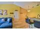 Cozy living space featuring a breakfast bar, modern lighting, and a comfortable blue sofa at 8341 38Th Street Cir E # 303, Sarasota, FL 34243