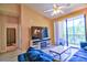 Bright living room with sliding glass doors to balcony, modern floors, and a ceiling fan at 8341 38Th Street Cir E # 303, Sarasota, FL 34243