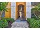 Exterior shot of the stairwell and walkway of a yellow condo complex at 8341 38Th Street Cir E # 303, Sarasota, FL 34243