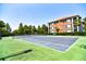 Well-maintained tennis court surrounded by trees and lush landscaping at 8341 38Th Street Cir E # 303, Sarasota, FL 34243