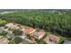 Stunning aerial view of homes with well-manicured lawns backing onto a dense, green wooded area at 9008 Brookfield Ter, Bradenton, FL 34212