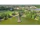 Aerial view of a park with a lake, pier, and green spaces, surrounded by houses and golf course at 9008 Brookfield Ter, Bradenton, FL 34212