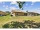 Expansive backyard featuring a well-maintained lawn, screened-in pool area, and lush landscaping at 9008 Brookfield Ter, Bradenton, FL 34212