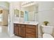 Bathroom with vanity, modern lighting, toilet, tiled floor, and access to another room at 9008 Brookfield Ter, Bradenton, FL 34212