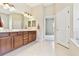 Bathroom features a double vanity, wood cabinets, and a large mirror at 9008 Brookfield Ter, Bradenton, FL 34212