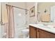 Traditional bathroom with white tiled shower, single sink vanity, and decorative accents at 9008 Brookfield Ter, Bradenton, FL 34212