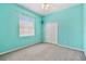 Bedroom featuring vibrant turquoise walls, a double closet, and a window with white blinds at 9008 Brookfield Ter, Bradenton, FL 34212