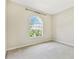 Bright bedroom features a large arched window and neutral carpet at 9008 Brookfield Ter, Bradenton, FL 34212