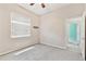 A light-filled bedroom with neutral walls, a window with blinds, carpeted floor, and a small hanging shelf with hooks at 9008 Brookfield Ter, Bradenton, FL 34212