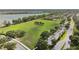 Aerial view of a lush park with soccer fields and amenities, surrounded by beautiful lake and trees at 9008 Brookfield Ter, Bradenton, FL 34212