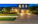 Stunning two-story home features a brick driveway, three car garage, and mature landscaping at 9008 Brookfield Ter, Bradenton, FL 34212