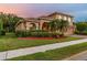 Lovely two-story home features a brick driveway, three-car garage, and lush landscaping at 9008 Brookfield Ter, Bradenton, FL 34212