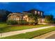Attractive two-story house boasts a brick driveway, three car garage, and landscaped front yard at 9008 Brookfield Ter, Bradenton, FL 34212