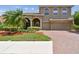 Beautiful two-story home with a three-car garage, brick paver driveway, and manicured lawn at 9008 Brookfield Ter, Bradenton, FL 34212