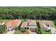 Aerial view of a well-maintained house with a backyard pool, surrounded by lush greenery and neighboring homes at 9008 Brookfield Ter, Bradenton, FL 34212