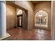 Welcoming foyer with brick floors, decorative windows, arched entryways, and a chandelier at 9008 Brookfield Ter, Bradenton, FL 34212