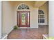 Inviting front entrance with a decorative front door, brick pavers and welcoming flower display at 9008 Brookfield Ter, Bradenton, FL 34212