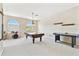 Spacious game room featuring a pool table, air hockey table, and large arched windows for natural light at 9008 Brookfield Ter, Bradenton, FL 34212