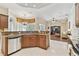 Spacious kitchen featuring stainless steel appliances, granite countertops, and view into the adjacent living area at 9008 Brookfield Ter, Bradenton, FL 34212